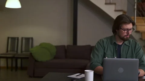 Young businessman or coach using laptop for remote work or self study at table Stock Footage 169496458