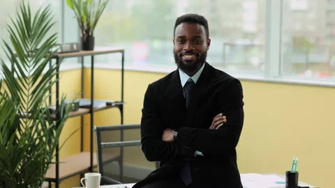 Young businessman or executive posing for camera and smiling while standing in Stock Footage 172463331