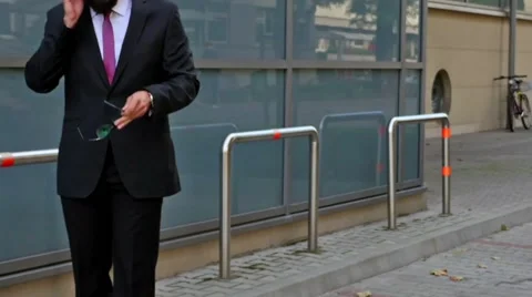 Young businessman outside the office using smartphone. Timelaps Stock Footage 56526471