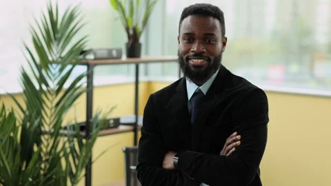 Young businessman posing for camera and smiling while standing in modern office Stock Footage 169020737