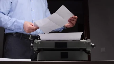 Young businessman preparing to type a document on an old qwerty machine Stock Footage 321621325