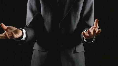 Young businessman presenting and explaining on black background Stock Footage 61016192