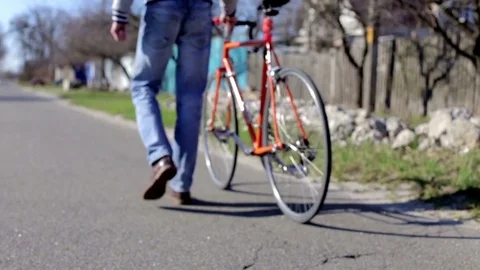 Young businessman rides a bicycle to work Stock Footage