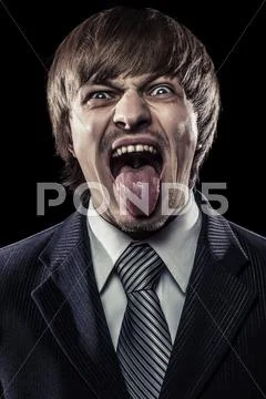 Young businessman shouting with his tongue stuck out Stock Photos