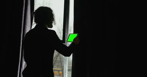 A young businessman sits at a computer, back view of freelancer gets up from Stock Footage 246584419