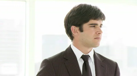 Young businessman smiling at the camera Stock Footage 564400