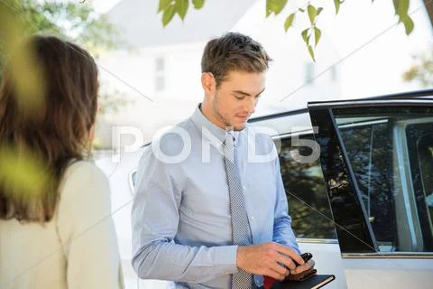 Young Businessman On Street Preparing To Leave In Car