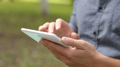 Young businessman with tablet computer sitting on bench in the park Stock Footage 67880915