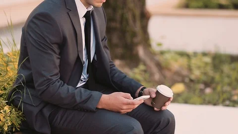 Young Businessman Talking At Phone While Drinking Coffee To Go Stock Footage 87406849