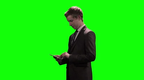 Young businessman texting on mobile device / cellphone against green screen Video stock 49547810