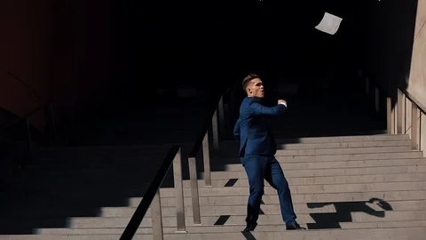 Young businessman throwing document and funny dancing near office building Stock Footage 91430966