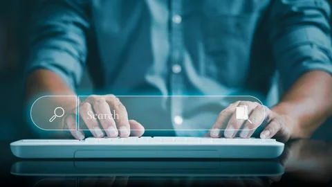 A young businessman is typing a document on a keyboard 스톡 사진