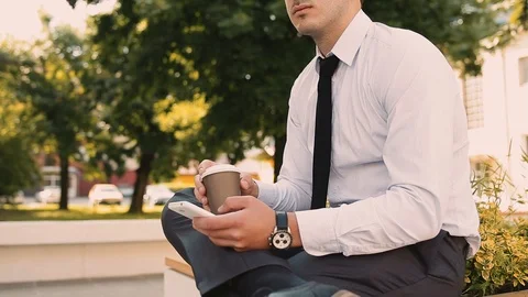 Young Businessman Typing On Phone While Drinking Coffee To Go Stock Footage 87408400