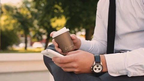 Young Businessman Typing On Phone While Drinking Coffee To Go Stock Footage 87408738