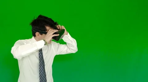 Young businessman using 3D VR glasses with green screen Stock Footage 61259204