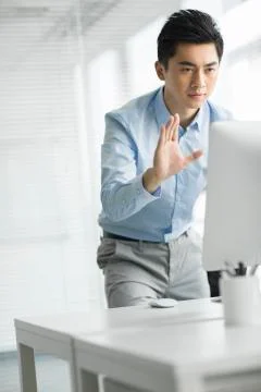 Young businessman using computer in office Stock Photos