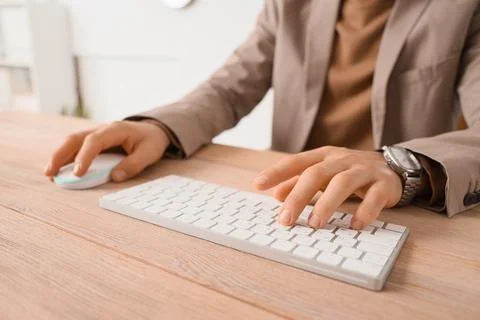 Young businessman using computer to search online in office, closeup Stock Photos
