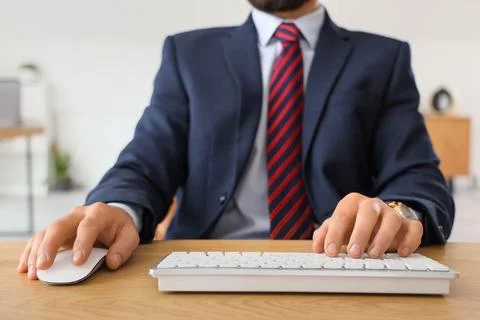 Young businessman using computer to search online in office, closeup Stock Photos