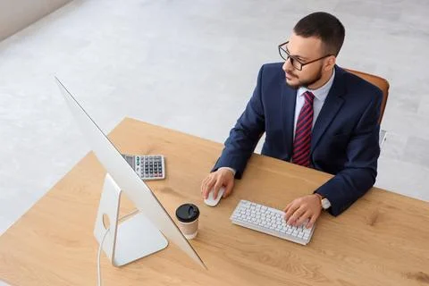 Young businessman using computer to search online in office Stock Photos