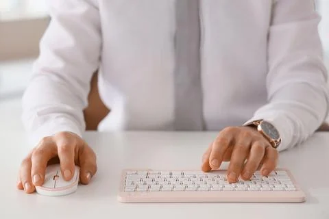 Young businessman using computer to search online at desk in office, closeup Stock Photos