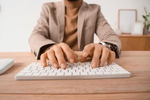 Young businessman using computer to search online in office, closeup Stock Photos