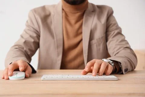Young businessman using computer to search online in office, closeup Stock Photos