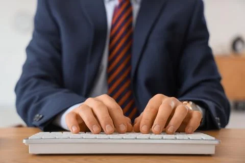 Young businessman using computer to search online in office, closeup Stock Photos