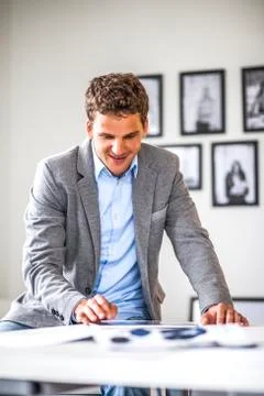 Young businessman using digital tablet in office Photos