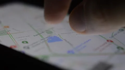 Young businessman using google gps on his iphone Stock Footage 202131950
