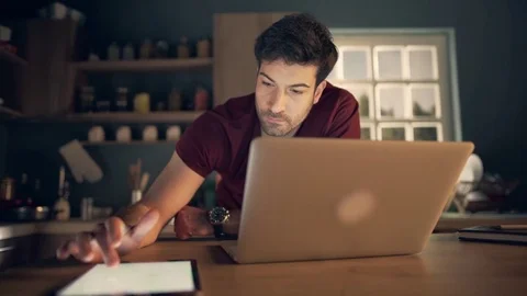 Young businessman using laptop and tablet Stock Footage