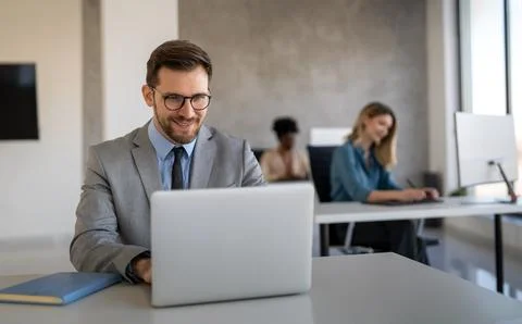 Young businessman using laptop computer in office. Manager thinks about suc.. Foto stock