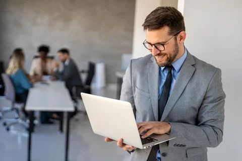 Young businessman using laptop computer in office. Manager thinks about Foto stock