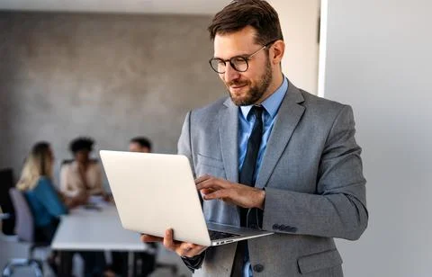 Young businessman using laptop computer in office. Manager thinks about suc.. 库存照片