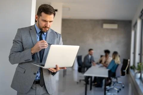 Young businessman using laptop computer in office. Manager thinks about suc.. 스톡 사진