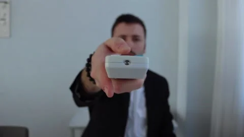 Young Businessman using Remote Control Stock Footage 148082852