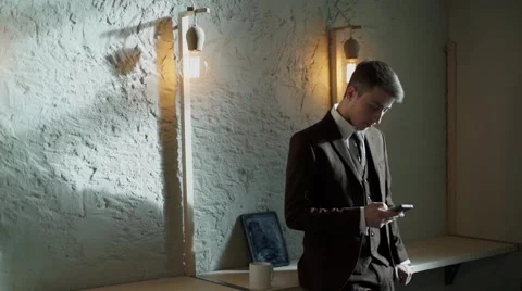 Young businessman using smartphone in cafe Stock Footage 56894458