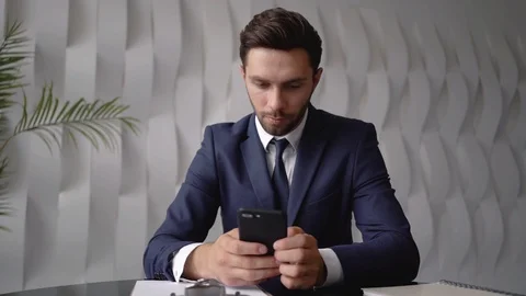 Young businessman using smartphone Stock Footage 93203616