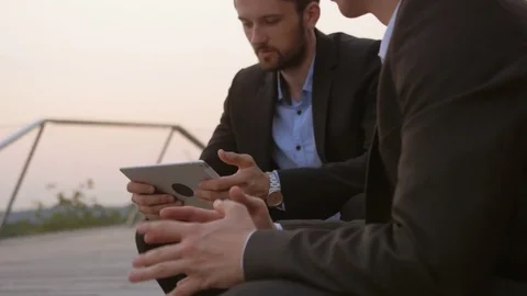 Young businessman using a tablet and sharing information. 動画素材 76049447