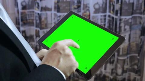 Young businessman using a tablet computer: alpha channel, green screen Stockbeeldmateriaal 47859877