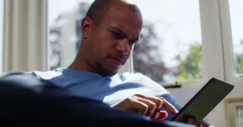 Young businessman using tablet computer for online shopping. Working from home. Stock Footage 55342883