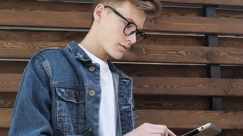 Young businessman using tablet computer touchscreen on the street Video stock 77396193