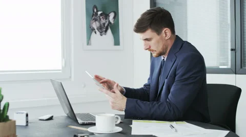 Young businessman using a tablet during his work Stock Footage 68395143