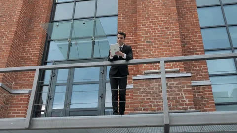 Young Businessman Using Tablet Outside Loft Office Stock Footage 94853088