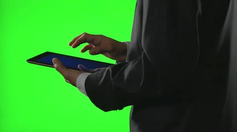 Young businessman using a tablet pc in a virtual business environment on gree Stock Footage 61015841