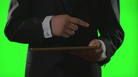 Young businessman using a tablet pc in a virtual business environment on gree Video stock 61015898