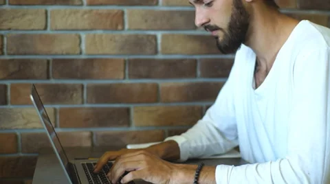 Young businessman while working on laptop computer , male freelancer in cafe Stock Footage 67099104