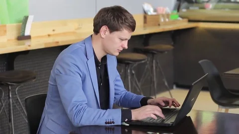 Young businessman working on computer in cafe Stock Footage 73963695