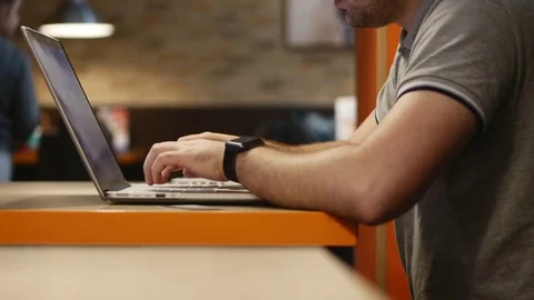 Young businessman working on computer in cafe. 4k. Stock Footage 79863474
