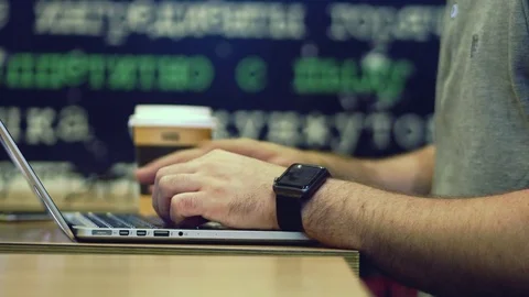 Young businessman working on computer in the caffe, dolly shot. 4K. Stock Footage 79848372