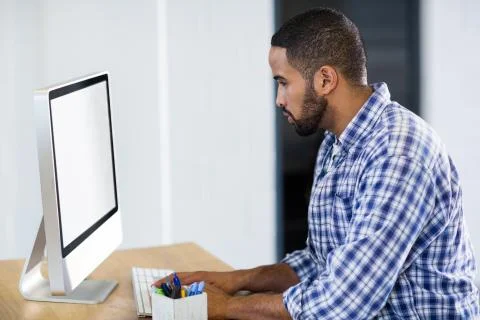 Young businessman working on computer in creative office 스톡 사진